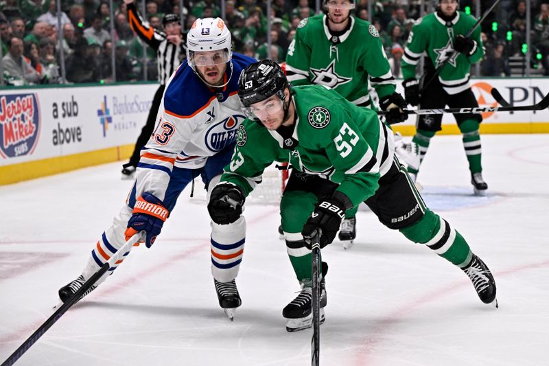 May 21, 2025; Dallas, Texas, USA; Dallas Stars center Wyatt Johnston (53) and Edmonton Oilers center Mattias Janmark (13) skate for a loose puck in the third period during game one of the Western Conference Final of the 2025 Stanley Cup Playoffs at American Airlines Center. Mandatory Credit: Jerome Miron-Imagn Images