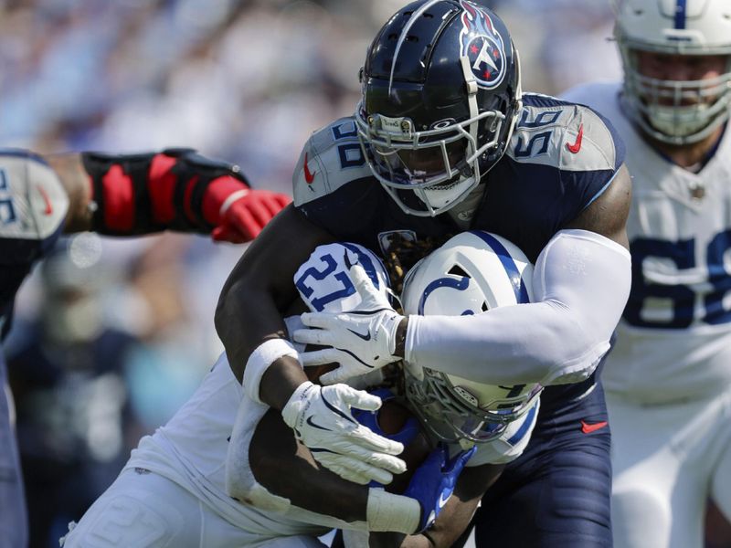 Indianapolis Colts running back Trey Sermon (27) is tackled by Tennessee Titans linebacker Kenneth Murray Jr. (56) during the first half of an NFL football game, Sunday, Oct. 13, 2024, in Nashville, Tenn. (AP Photo/Stew Milne)