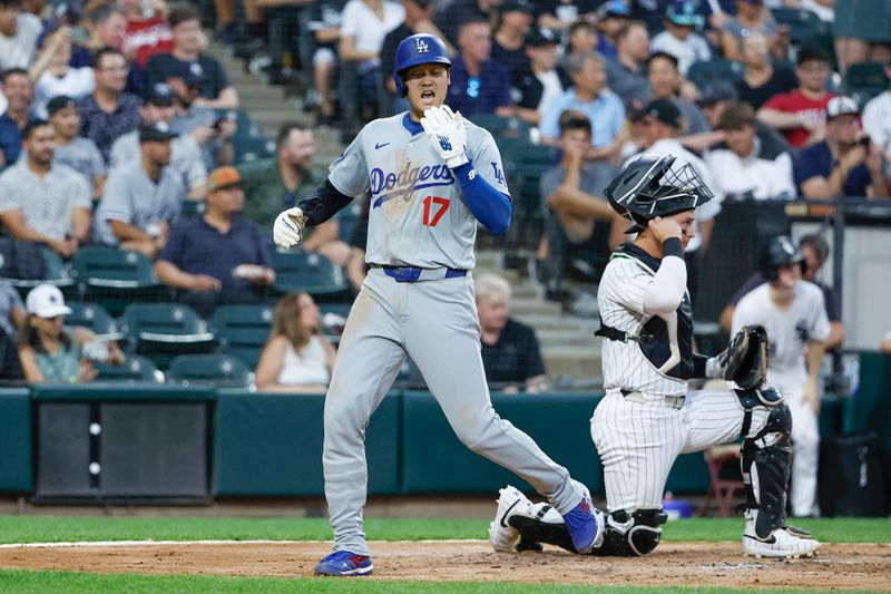 Jun 25, 2024; Chicago, Illinois, USA; Los Angeles Dodgers designated hitter Shohei Ohtani (17) reacts after scoring against the Chicago White Sox during the third inning at Guaranteed Rate Field. Mandatory Credit: Kamil Krzaczynski-USA TODAY Sports