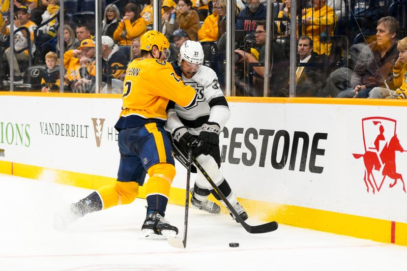 Nov 4, 2024; Nashville, Tennessee, USA;  Nashville Predators defenseman Luke Schenn (2) checks Los Angeles Kings left wing Warren Foegele (37) during the second period at Bridgestone Arena. Mandatory Credit: Steve Roberts-Imagn Images