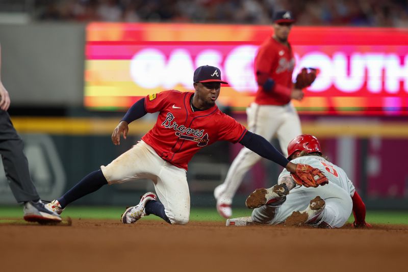 Jul 5, 2024; Atlanta, Georgia, USA; Philadelphia Phillies designated hitter Bryson Stott (5) steals second past Atlanta Braves second baseman Ozzie Albies (1) in the seventh inning at Truist Park. Mandatory Credit: Brett Davis-USA TODAY Sports