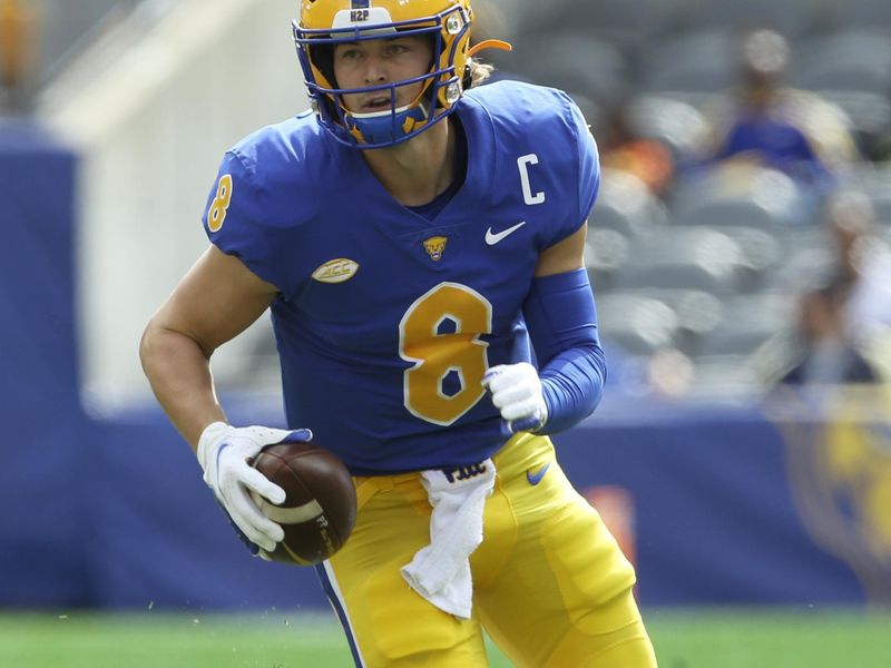 Sep 25, 2021; Pittsburgh, Pennsylvania, USA;  Pittsburgh Panthers quarterback Kenny Pickett (8) rushes the ball against the New Hampshire Wildcats during the first quarter at Heinz Field. Mandatory Credit: Charles LeClaire-USA TODAY Sports