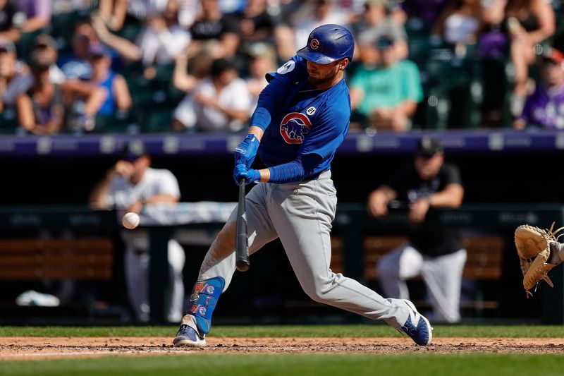 Sep 15, 2024; Denver, Colorado, USA; Chicago Cubs first baseman Michael Busch (29) hits a solo home run in the seventh inning against the Colorado Rockies at Coors Field. Mandatory Credit: Isaiah J. Downing-Imagn Images