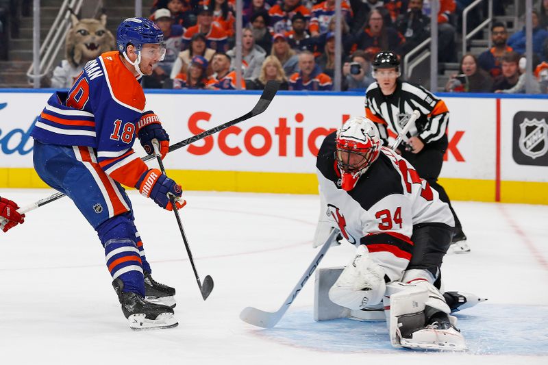 Nov 4, 2024; Edmonton, Alberta, CAN;  New Jersey Devils goaltender Jake Allen (34) makes a save on  Edmonton Oilers forward Zach Hyman (18) during the first period at Rogers Place. Mandatory Credit: Perry Nelson-Imagn Images