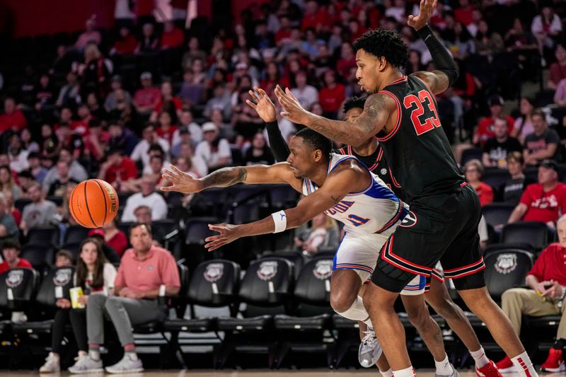 Feb 28, 2023; Athens, Georgia, USA; Florida Gators guard Kyle Lofton (11) passes the ball under Georgia Bulldogs center Braelen Bridges (23) during the first half at Stegeman Coliseum. Mandatory Credit: Dale Zanine-USA TODAY Sports