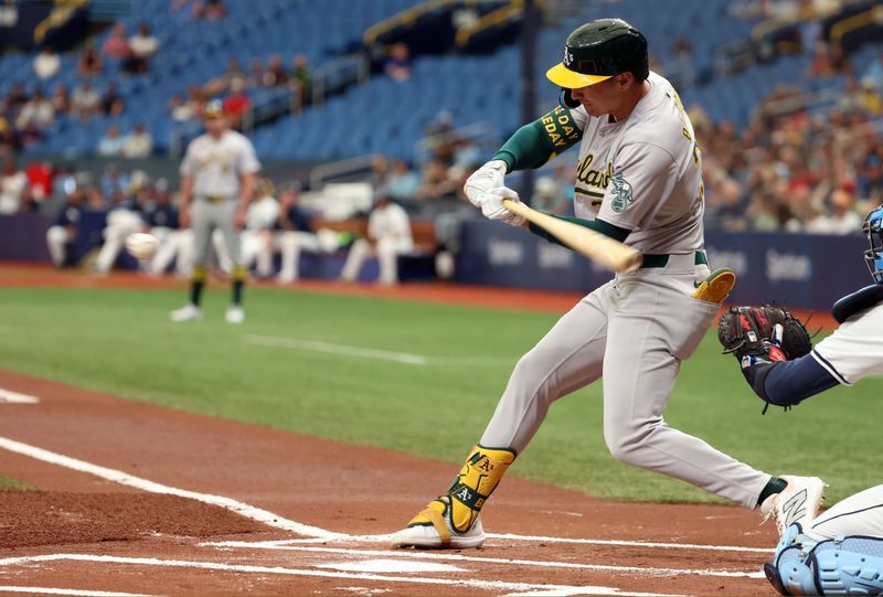 May 30, 2024; St. Petersburg, Florida, USA; Oakland Athletics outfielder JJ Bleday (33) singles against the Tampa Bay Rays during the first inning  at Tropicana Field. Mandatory Credit: Kim Klement Neitzel-USA TODAY Sports