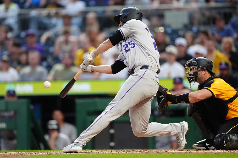 May 3, 2024; Pittsburgh, Pennsylvania, USA; Colorado Rockies catcher Jacob Stallings (25) hits a single against the Pittsburgh Pirates during the fifth inning at PNC Park. Mandatory Credit: Gregory Fisher-USA TODAY Sports