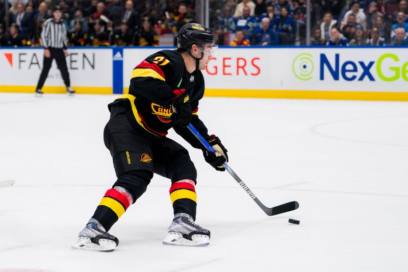 Dec 12, 2023; Vancouver, British Columbia, CAN; Vancouver Canucks forward Nils Hoglander (21) handles the puck against the Tampa Bay Lightning in the second period at Rogers Arena. Mandatory Credit: Bob Frid-USA TODAY Sports