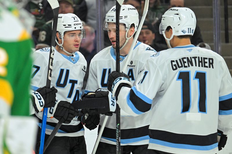Oct 25, 2025; Saint Paul, Minnesota, USA;  Utah Mammoth forward JJ Peterka (77) celebrates his goal against the Minnesota Wild with defensemen Mikhail Sergachev (98) and forward Dylan Guenther (11) during the third period at Grand Casino Arena. Mandatory Credit: Nick Wosika-Imagn Images