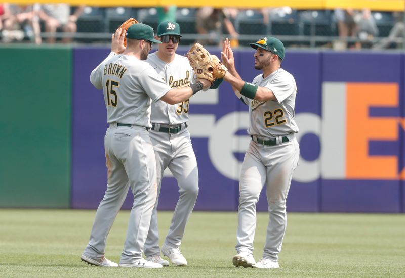 Jun 7, 2023; Pittsburgh, Pennsylvania, USA;  Oakland Athletics left fielder Seth Brown (15) and center fielder JJ Bleday (33) and right fielder Ramon Laureano (22) celebrate in the outfield after defeating the Pittsburgh Pirates at PNC Park. Oakland won 9-5. Mandatory Credit: Charles LeClaire-USA TODAY Sports