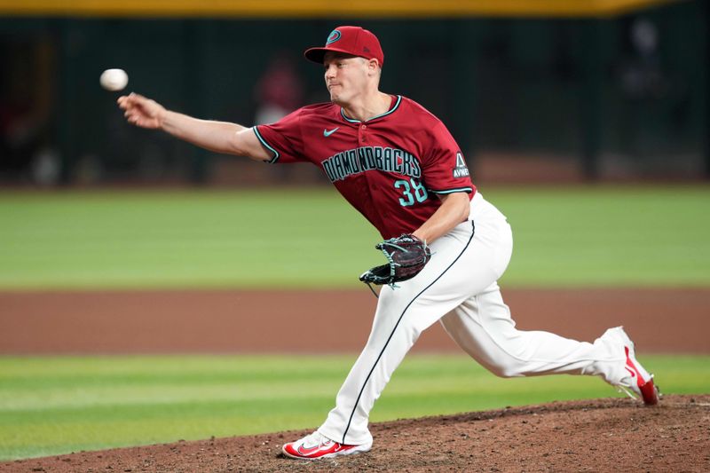 May 25, 2024; Phoenix, Arizona, USA; Arizona Diamondbacks pitcher Paul Sewald (38) pitches against the Miami Marlins during the ninth inning at Chase Field. Mandatory Credit: Joe Camporeale-USA TODAY Sports