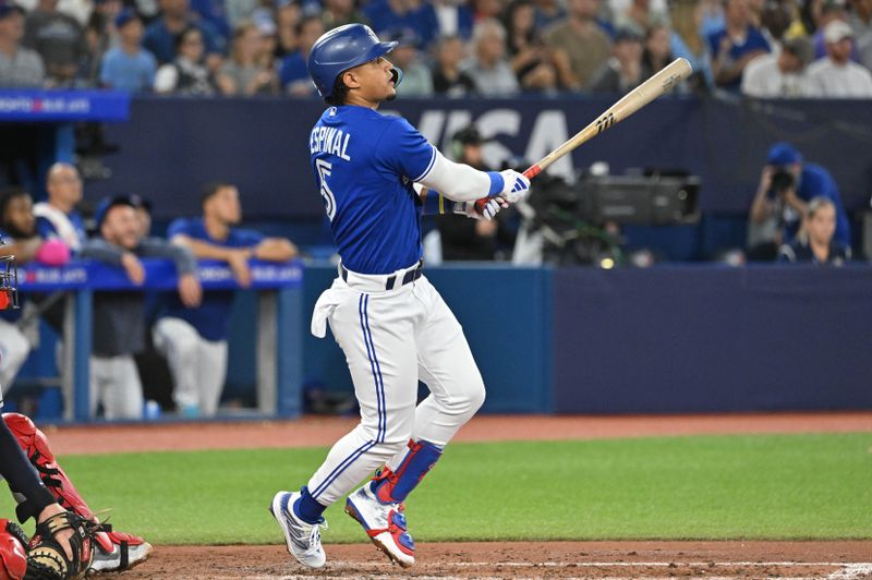 Aug 26, 2023; Toronto, Ontario, CAN;  Toronto Blue Jays shortstop Santiago Espinal (5) hits an RBI double against the Cleveland Guardians in the fourth inning at Rogers Centre. Mandatory Credit: Dan Hamilton-USA TODAY Sports