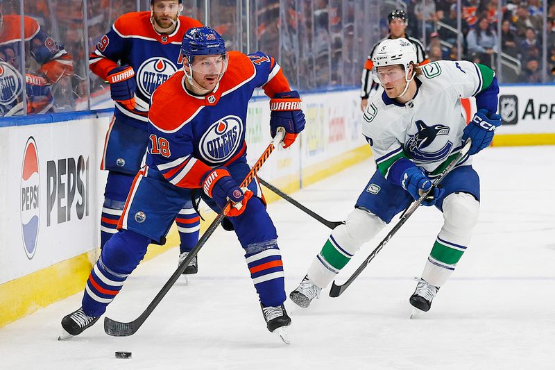 Apr 13, 2024; Edmonton, Alberta, CAN; Edmonton Oilers forward Zach Hyman (18) looks to make a pass in front of Vancouver Canucks forward Brock Boeser (6) during the third period at Rogers Place. Mandatory Credit: Perry Nelson-USA TODAY Sports