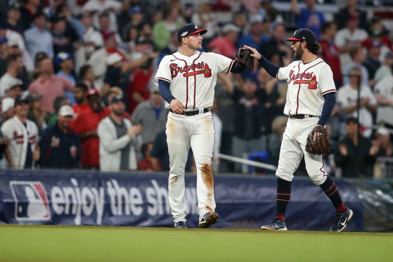 Oct 12, 2022; Atlanta, Georgia, USA; Atlanta Braves third baseman Austin Riley (left) high-fives shortstop Dansby Swanson (7) after catching a foul ball for an out against the Philadelphia Phillies in the eighth inning during game two of the NLDS for the 2022 MLB Playoffs at Truist Park. Mandatory Credit: Brett Davis-USA TODAY Sports