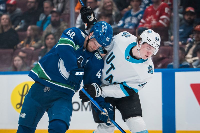 Mar 16, 2025; Vancouver, British Columbia, CAN; Vancouver Canucks forward Elias Pettersson (40) battles with Utah Hockey Club forward Logan Cooley (92) in the third period at Rogers Arena. Mandatory Credit: Bob Frid-Imagn Images