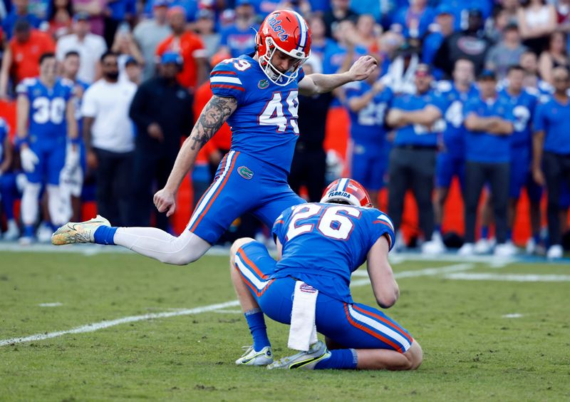 Nov 12, 2022; Gainesville, Florida, USA;Florida Gators place kicker Adam Mihalek (49) makes a field goal against the South Carolina Gamecocks during the second quarter at Ben Hill Griffin Stadium. Mandatory Credit: Kim Klement-USA TODAY Sports