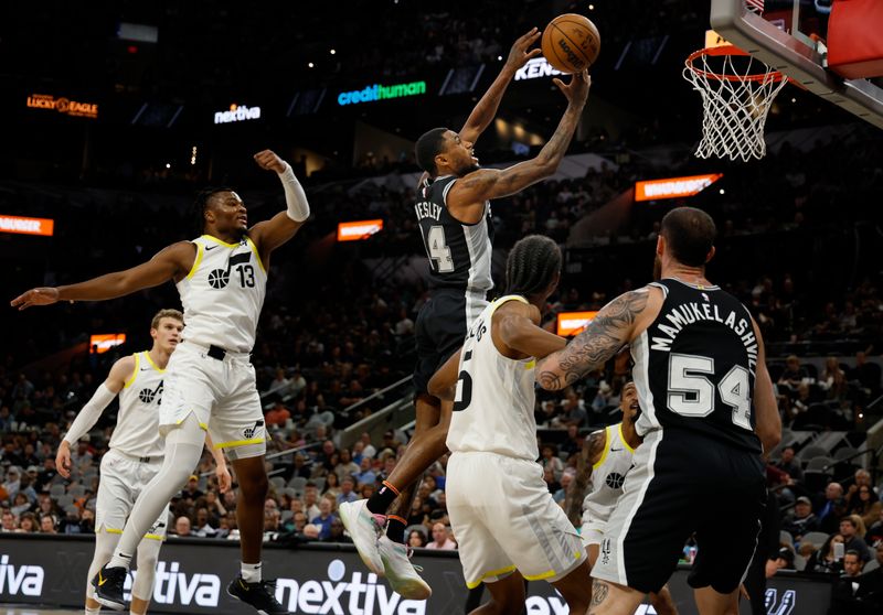 SAN ANTONIO, TX - NOVEMBER 9:  Blake Wesley #14 of the San Antonio Spurs drives to the basket past Isaiah Collier #13 of the Utah Jazz in the first half at Frost Bank Center on November 9, 2024 in San Antonio, Texas. NOTE TO USER: User expressly acknowledges and agrees that, by downloading and or using this photograph, User is consenting to terms and conditions of the Getty Images License Agreement. (Photo by Ronald Cortes/Getty Images)