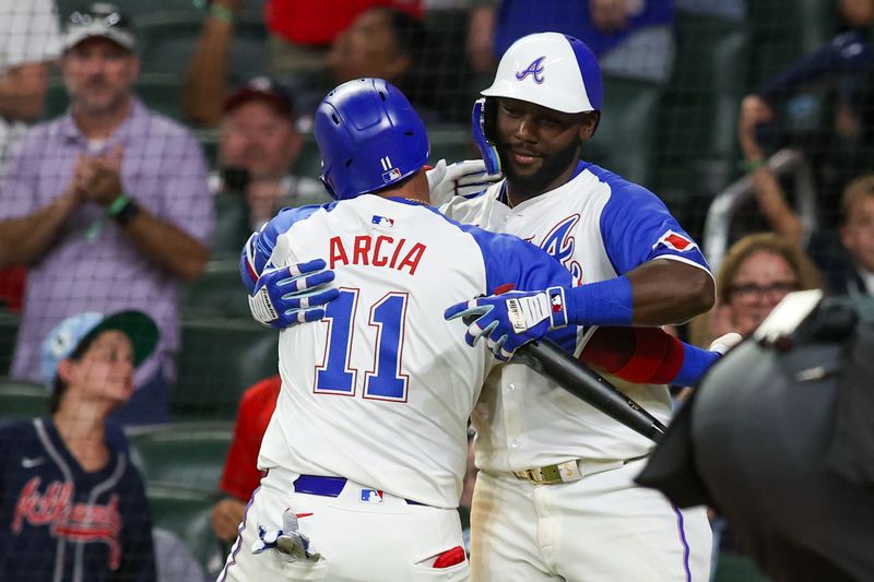 Aug 24, 2024; Atlanta, Georgia, USA; Atlanta Braves shortstop Orlando Arcia (11) celebrates with center fielder Michael Harris II (23) after a home run against the Washington Nationals in the fifth inning at Truist Park. Mandatory Credit: Brett Davis-USA TODAY Sports