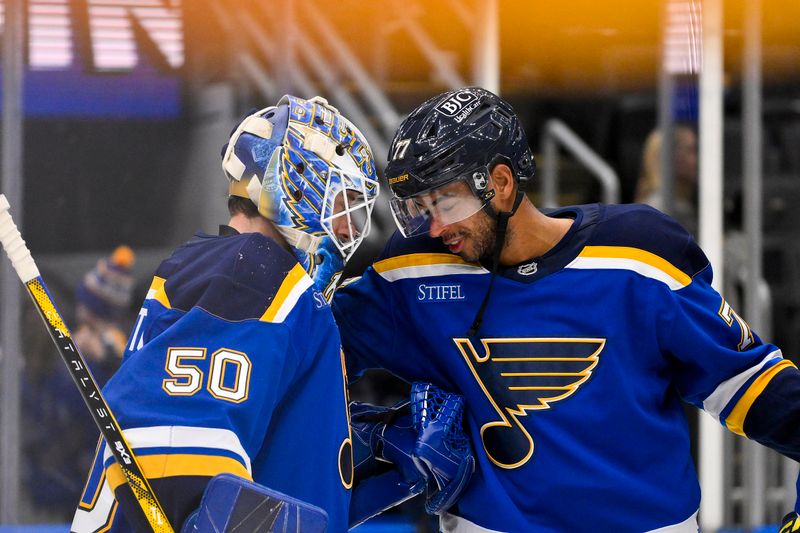 Nov 5, 2024; St. Louis, Missouri, USA;  St. Louis Blues goaltender Jordan Binnington (50) celebrates with defenseman Pierre-Olivier Joseph (77) after the Blues defeated the Tampa Bay Lightning at Enterprise Center. Mandatory Credit: Jeff Curry-Imagn Images