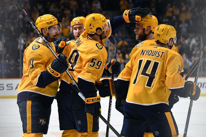 Apr 4, 2024; Nashville, Tennessee, USA; Nashville Predators left wing Filip Forsberg (9) celebrates with teammates after an empty net goal during the third period against the St. Louis Blues at Bridgestone Arena. Mandatory Credit: Christopher Hanewinckel-USA TODAY Sports