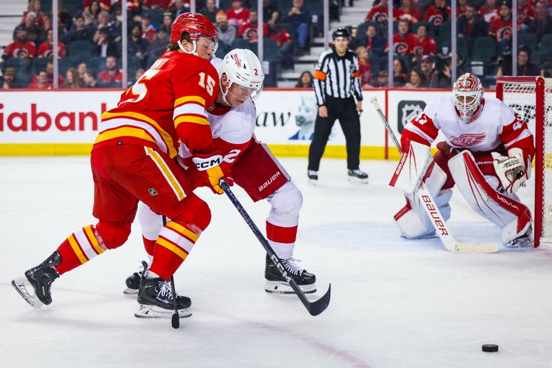 Feb 17, 2024; Calgary, Alberta, CAN; Calgary Flames left wing Dryden Hunt (15) and Detroit Red Wings defenseman Olli Maatta (2) battles for the puck during the third period at Scotiabank Saddledome. Mandatory Credit: Sergei Belski-USA TODAY Sports