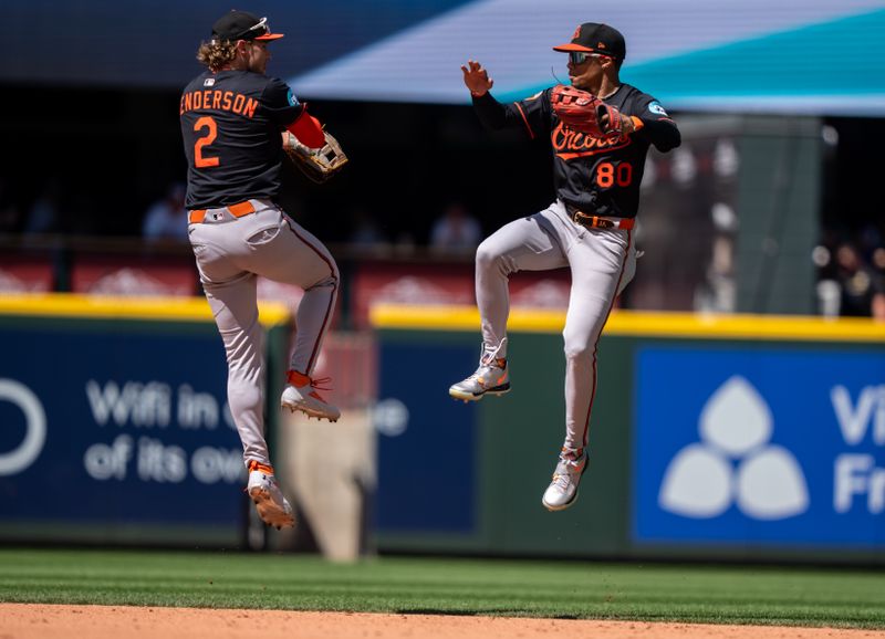 Jun 5, 2025; Seattle, Washington, USA;  Balitimore Orioles centerfielder Jordyn Adams (80) and shortstop Gunnar Henderson (2) celebrate after a game against the Seattle Mariners at T-Mobile Park. Mandatory Credit: Stephen Brashear-Imagn Images