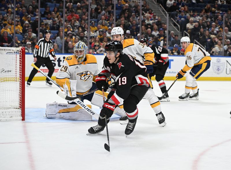 Jan 31, 2025; Buffalo, New York, USA; Buffalo Sabres center Peyton Krebs (19) watches the puck along with Nashville Predators goaltender Justus Annunen (29) and defenseman Nick Blankenburg (37) in the second period at the KeyBank Center. Mandatory Credit: Mark Konezny-Imagn Images