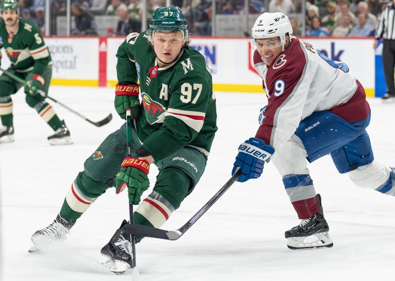 Apr 4, 2024; Saint Paul, Minnesota, USA; Minnesota Wild left wing Kirill Kaprizov (97) and Colorado Avalanche left wing Zach Parise (9) look for the puck in the third period at Xcel Energy Center. Mandatory Credit: Matt Blewett-USA TODAY Sports