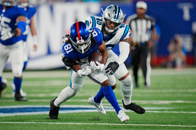 New York Giants wide receiver Kalil Pimpleton (81) is tackled by Carolina Panthers linebacker Brandon Smith (40) during an NFL pre-season football game on Friday, Aug. 18, 2023, in East Rutherford, N.J. (AP Photo/Rusty Jones)