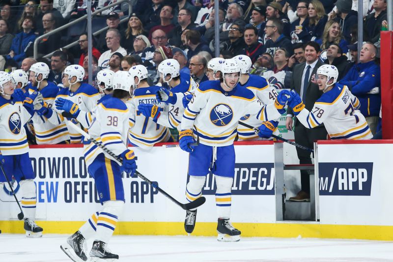 Jan 26, 2023; Winnipeg, Manitoba, CAN;  Buffalo Sabres forward Owen Power (25) is congratulated by his team mates on his goal against the Winnipeg Jets during the second period at Canada Life Centre. Mandatory Credit: Terrence Lee-USA TODAY Sports