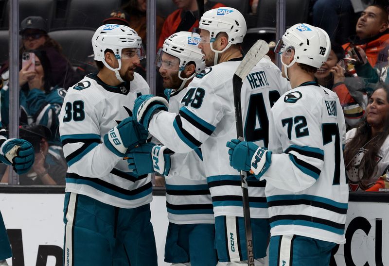 Nov 12, 2023; Anaheim, California, USA; San Jose Sharks center Luke Kunin (11) celebrates with teammates after scoring during the first period against the Anaheim Ducks at Honda Center. Mandatory Credit: Jason Parkhurst-USA TODAY Sports