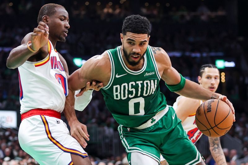 BOSTON, MA - NOVEMBER 6  Jayson Tatum #0 of the Boston Celtics drives against Jonathan Kuminga #00 of the Golden State Warriors during the first quarter at TD Garden on November 6, 2024 in Boston, Massachusetts. NOTE TO USER: User expressly acknowledges and agrees that, by downloading and or using this photograph, User is consenting to the terms and conditions of the Getty Images License Agreement. (Photo by Adam Glanzman/Getty Images)