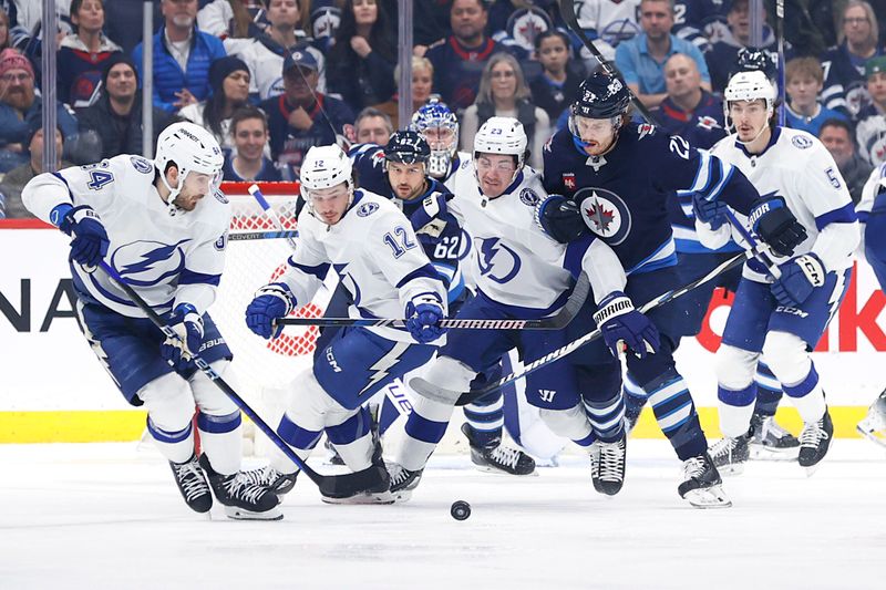 Jan 2, 2024; Winnipeg, Manitoba, CAN; Tampa Bay Lightning center Tyler Motte (64) gets set to clear the puck against the Winnipeg Jets in the first period at Canada Life Centre. Mandatory Credit: James Carey Lauder-USA TODAY Sports