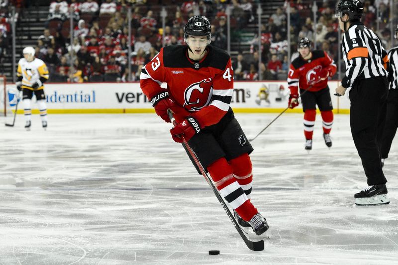 Apr 2, 2024; Newark, New Jersey, USA; New Jersey Devils defenseman Luke Hughes (43) skates with the puck during the third period against the Pittsburgh Penguins at Prudential Center. Mandatory Credit: John Jones-USA TODAY Sports