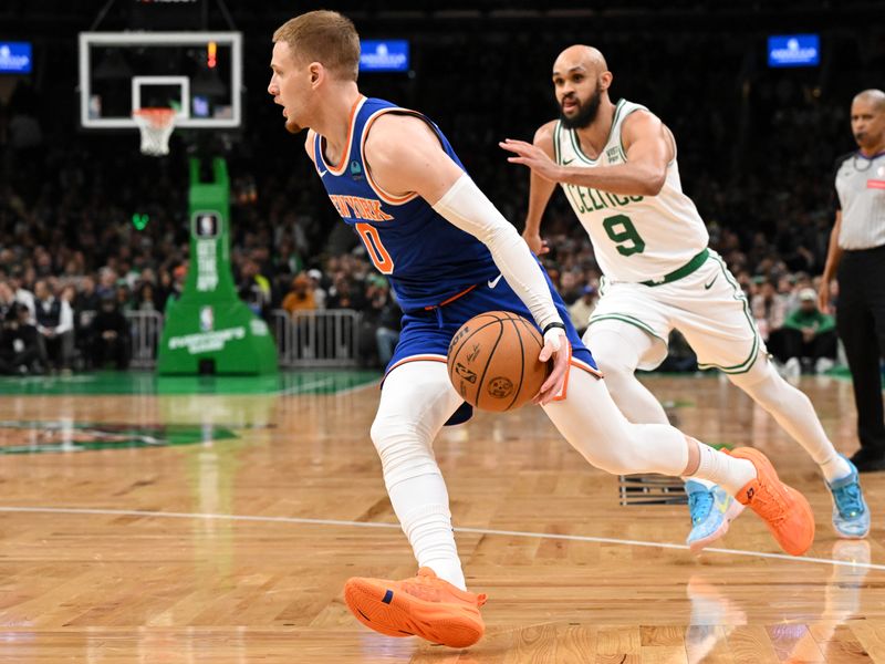 BOSTON, MASSACHUSETTS - APRIL 11: Donte DiVincenzo #0 of the New York Knicks drives to the basket against Derrick White #9 of the Boston Celtics during the first quarter at the TD Garden on April 11, 2024 in Boston, Massachusetts. NOTE TO USER: User expressly acknowledges and agrees that, by downloading and or using this photograph, User is consenting to the terms and conditions of the Getty Images License Agreement. (Photo by Brian Fluharty/Getty Images)