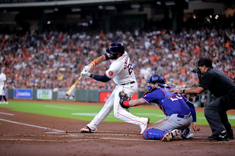 Jul 13, 2024; Houston, Texas, USA; Houston Astros first baseman Jon Singleton (28) hits a single against the Texas Rangers during the first inning at Minute Maid Park. Mandatory Credit: Erik Williams-USA TODAY Sports