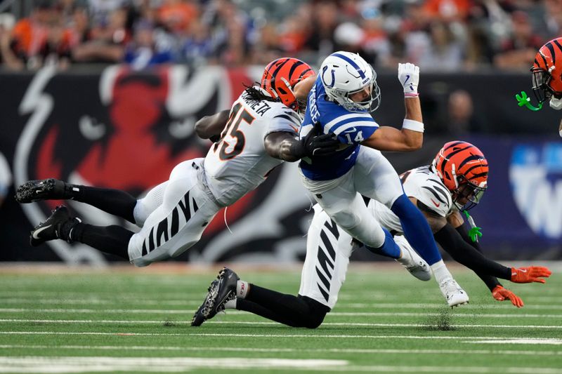 Indianapolis Colts wide receiver Alec Pierce (14) is tackled by Cincinnati Bengals linebacker Maema Njongmeta (45) during the first half of a preseason NFL football game, Thursday, Aug. 22, 2024, in Cincinnati. (AP Photo/Carolyn Kaster)