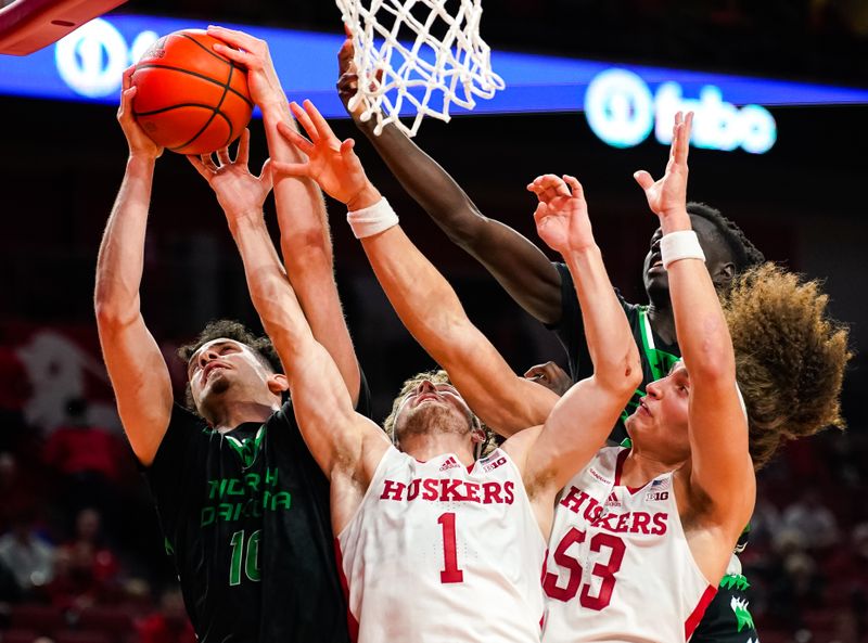 Dec 20, 2023; Lincoln, Nebraska, USA; North Dakota Fighting Hawks forward Tsotne Tsartsidze (10) shoots the ball against Nebraska Cornhuskers guard Sam Hoiberg (1) and forward Josiah Allick (53) during the second half at Pinnacle Bank Arena. Mandatory Credit: Dylan Widger-USA TODAY Sports