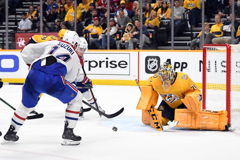Mar 5, 2024; Nashville, Tennessee, USA; Nashville Predators goaltender Juuse Saros (74) makes a save on a shot by Montreal Canadiens center Nick Suzuki (14) during the second period at Bridgestone Arena. Mandatory Credit: Christopher Hanewinckel-USA TODAY Sports