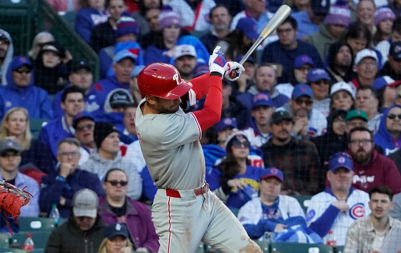 Apr 27, 2025; Chicago, Illinois, USA; Philadelphia Phillies shortstop Trea Turner (7) hits a one run single against the Chicago Cubs during the third inning at Wrigley Field. Mandatory Credit: David Banks-Imagn Images