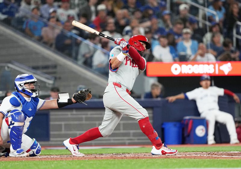 Sep 3, 2024; Toronto, Ontario, CAN; Philadelphia Phillies designated hitter Kyle Schwarber (12) hits a home run against the Toronto Blue Jays during the fourth inning at Rogers Centre. Mandatory Credit: Nick Turchiaro-Imagn Images