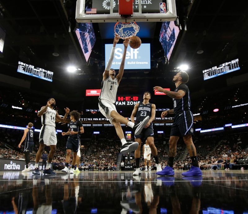 SAN ANTONIO, TX - OCTOBER 09:  Victor Wembanyama #1 of the San Antonio Spurs dunks against the Orlando Magic in the first half of a preseason game at Frost Bank Center on October 9, 2024 in San Antonio, Texas. NOTE TO USER: User expressly acknowledges and agrees that, by downloading and or using this photograph, User is consenting to terms and conditions of the Getty Images License Agreement. (Photo by Ronald Cortes/Getty Images)