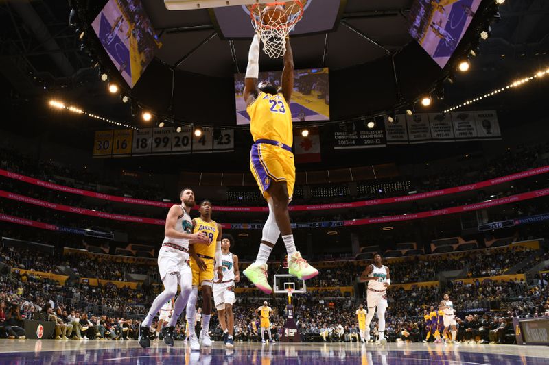 LOS ANGELES, CA - NOVEMBER 13: LeBron James #23 of the Los Angeles Lakers dunks the ball during the game against the Memphis Grizzlies on November 13, 2024 at Crypto.Com Arena in Los Angeles, California. NOTE TO USER: User expressly acknowledges and agrees that, by downloading and/or using this Photograph, user is consenting to the terms and conditions of the Getty Images License Agreement. Mandatory Copyright Notice: Copyright 2024 NBAE (Photo by Adam Pantozzi/NBAE via Getty Images)