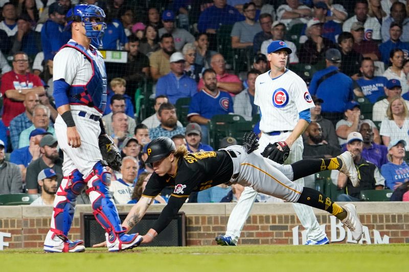 Sep 21, 2023; Chicago, Illinois, USA; Pittsburgh Pirates center fielder Jack Suwinski (65) is safe at home plate as Chicago Cubs catcher Yan Gomes (15) stands nearby during the third inning at Wrigley Field. Mandatory Credit: David Banks-USA TODAY Sports