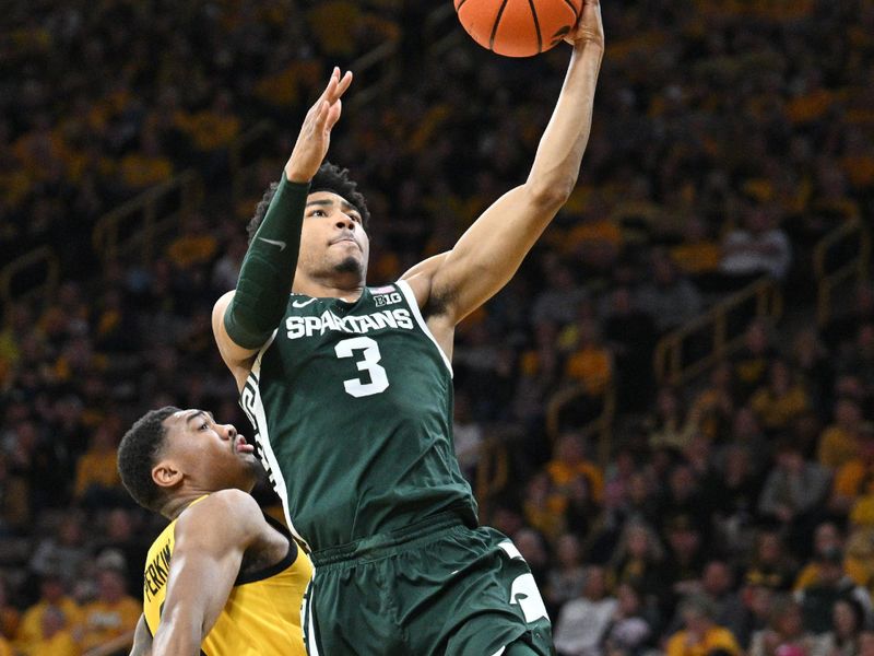 Feb 25, 2023; Iowa City, Iowa, USA; Michigan State Spartans guard Jaden Akins (3) goes to the basket as Iowa Hawkeyes guard Tony Perkins (11) defends during the second half at Carver-Hawkeye Arena. Mandatory Credit: Jeffrey Becker-USA TODAY Sports