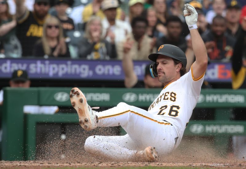 May 25, 2025; Pittsburgh, Pennsylvania, USA; Pittsburgh Pirates second baseman Adam Frazier (26) slides home to score a run against the Milwaukee Brewers during the sixth inning at PNC Park. Mandatory Credit: Charles LeClaire-Imagn Images
