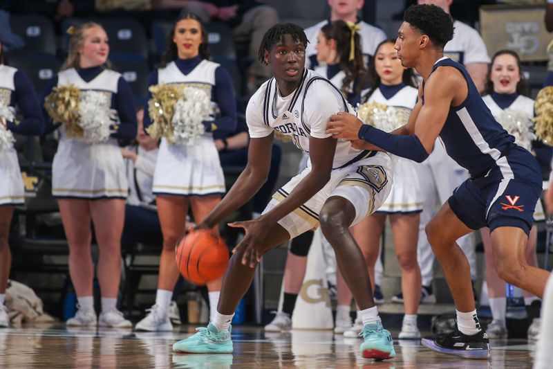 Jan 20, 2024; Atlanta, Georgia, USA; Georgia Tech Yellow Jackets forward Baye Ndongo (11) is defended by Virginia Cavaliers guard Ryan Dunn (13) in the first half at McCamish Pavilion. Mandatory Credit: Brett Davis-USA TODAY Sports
