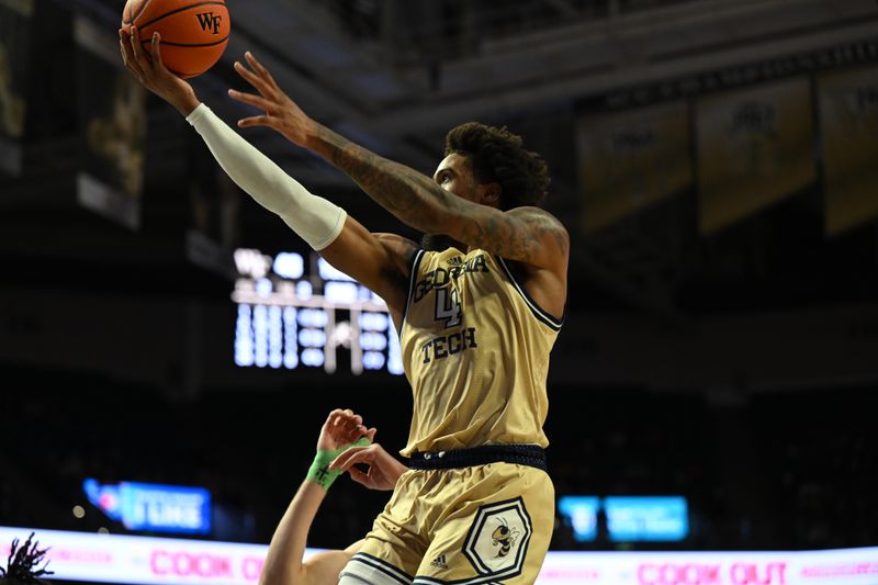 Feb 11, 2023; Winston-Salem, North Carolina, USA; Georgia Tech Yellow Jackets forward Javon Franklin (4) shoots a layup against the Wake Forest Demon Deacons during the second half at Lawrence Joel Veterans Memorial Coliseum. Mandatory Credit: William Howard-USA TODAY Sports