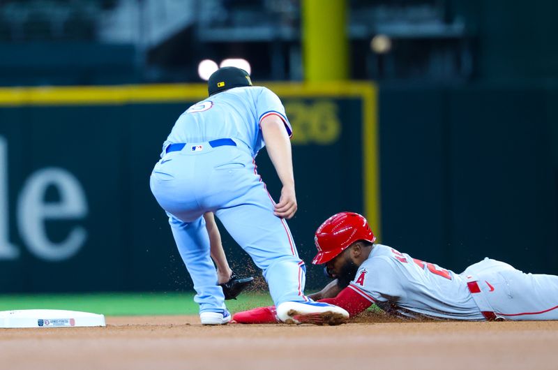 May 19, 2024; Arlington, Texas, USA; Texas Rangers shortstop Corey Seager (5) tags out Los Angeles Angels third baseman Luis Rengifo (2) at second base during the first inning at Globe Life Field. Mandatory Credit: Kevin Jairaj-USA TODAY Sports