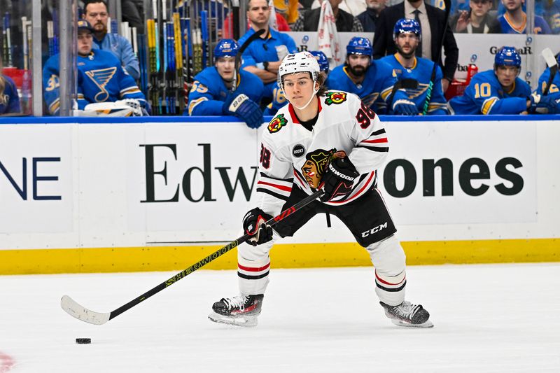 Dec 23, 2023; St. Louis, Missouri, USA;  Chicago Blackhawks center Connor Bedard (98) controls the puck against the St. Louis Blues during the first period at Enterprise Center. Mandatory Credit: Jeff Curry-USA TODAY Sports